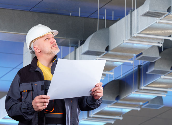 Engineer inspecting ventilation system design